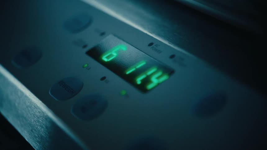 A digital panel with green numbers and around it there are some buttons