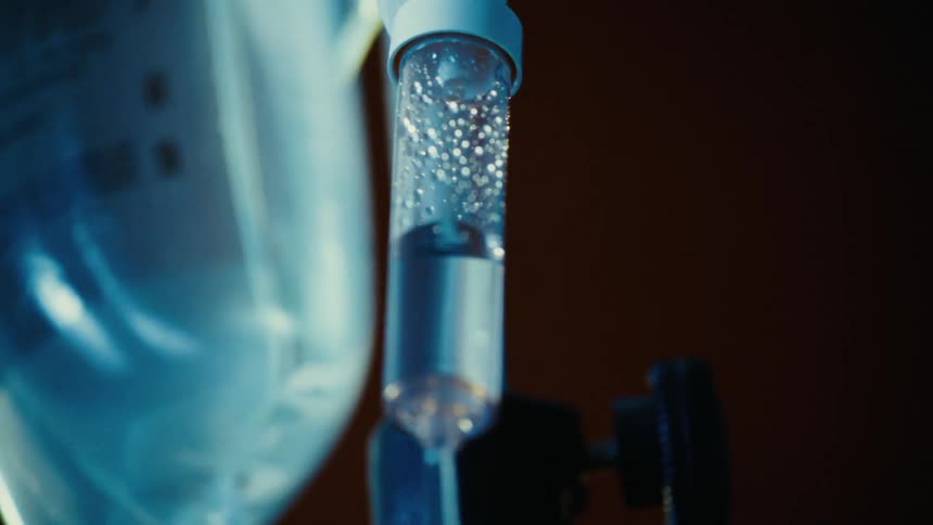 Ampoule and a small bag with drops of serum falling out