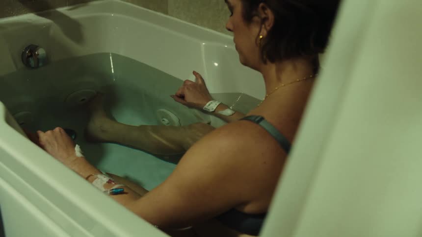 A woman sits in a hospital tub