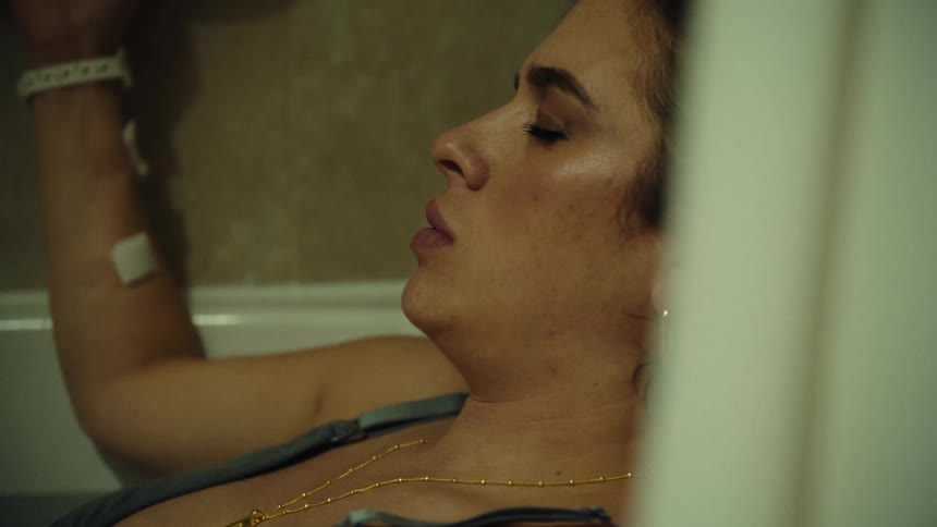 Woman lying in a bathtub taking deep breaths