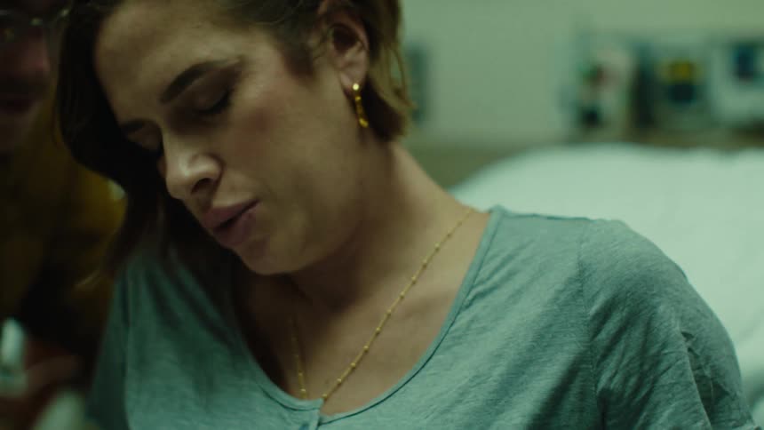 A woman sits in bed