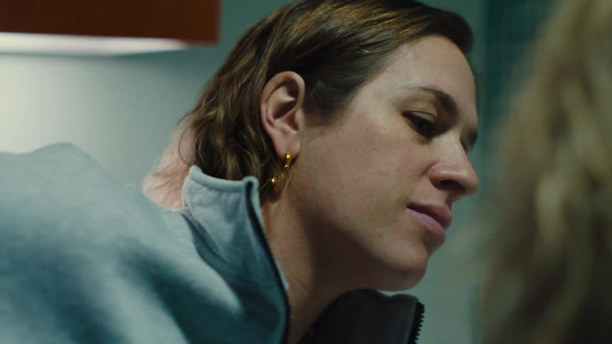 A woman leaning in and listening attentively to what another person is saying