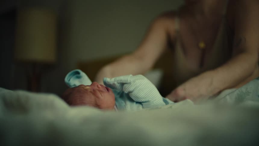 A mother is changing her babys pampers