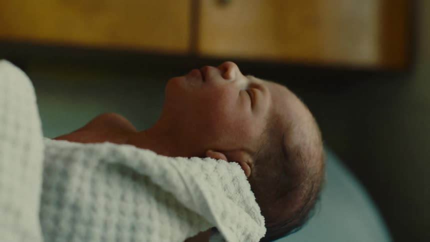 Person holding a newborn baby