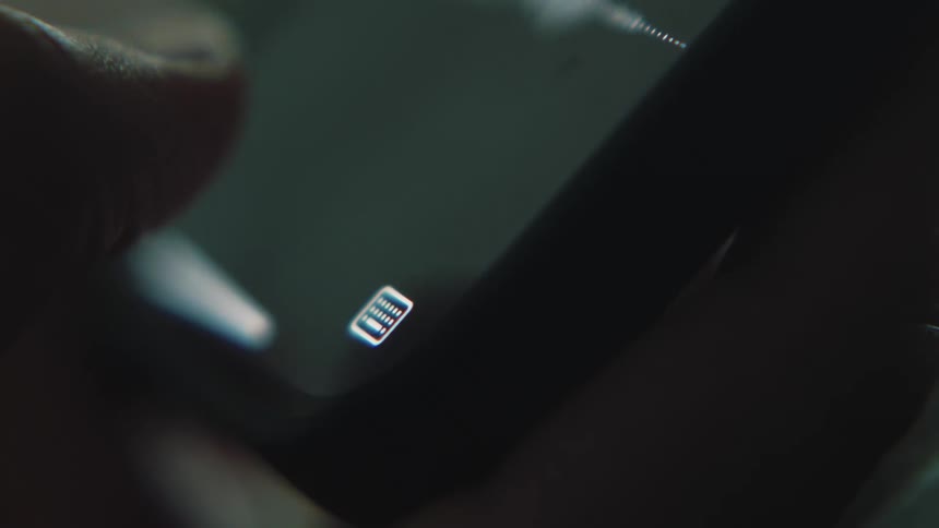 A thumb presses the microphone button in a smartphone chat