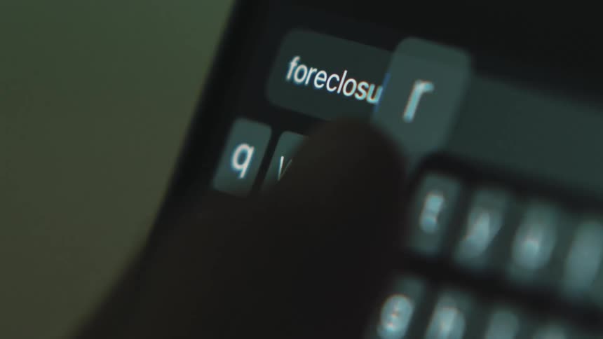 Person texts on smartphone in dimly lit area