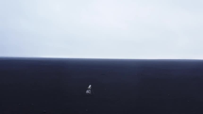 A person in a white robe walks