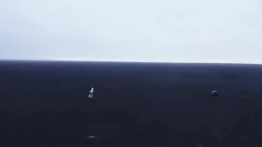 A person walks across the land