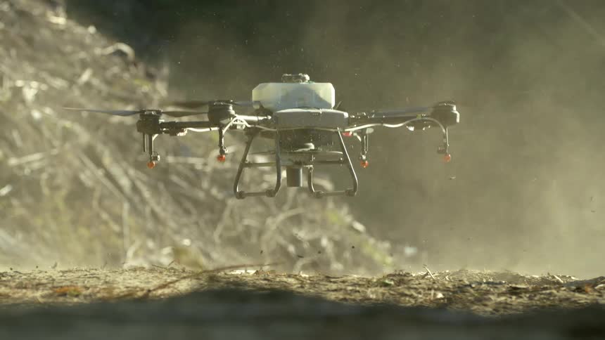 Large Quad propeller seeding drone taking off in slow motion