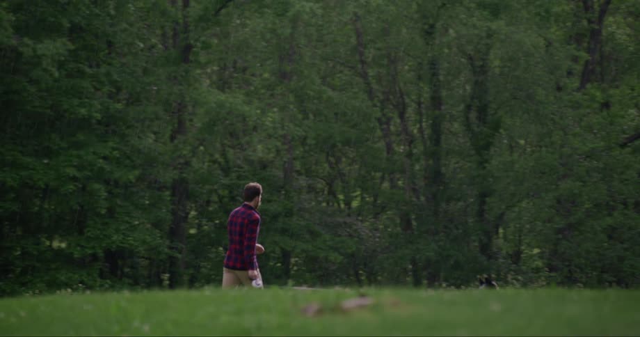 Man walking his dog near a forest