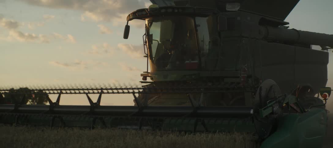 A combine harvester plowing a field