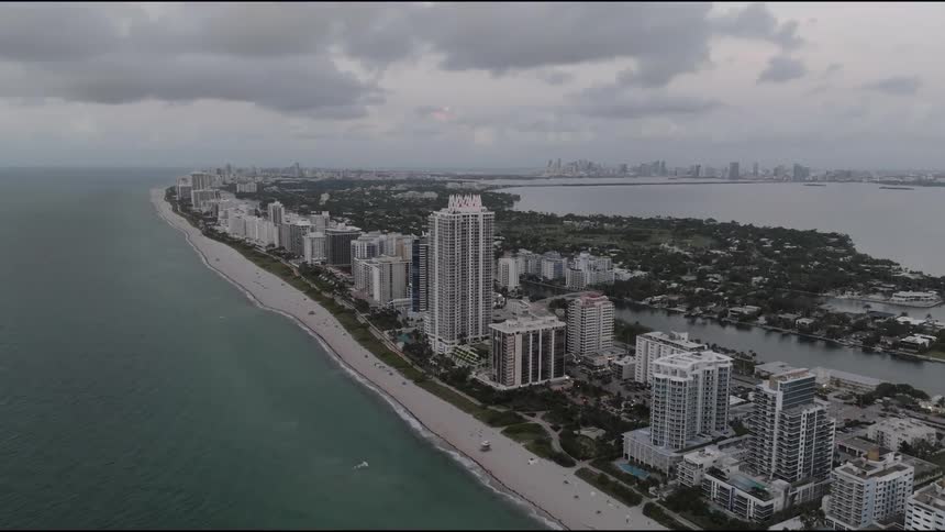 Aerial view of a coastal city skyline with highrise buildings lining the shore