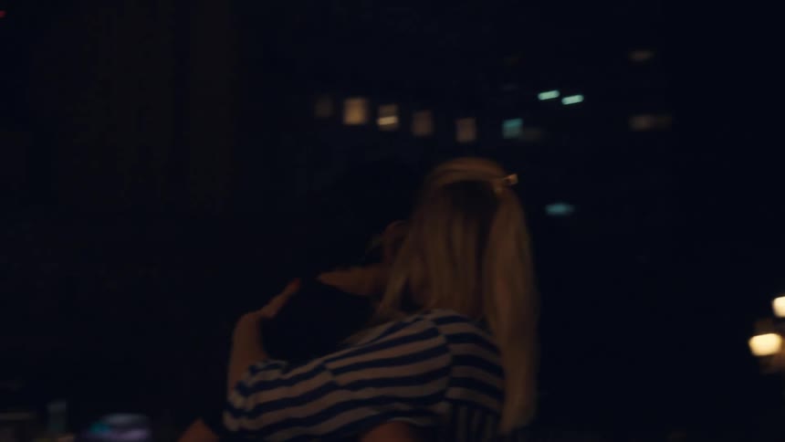 Woman and man in a tango choreography at night in a public square in the city
