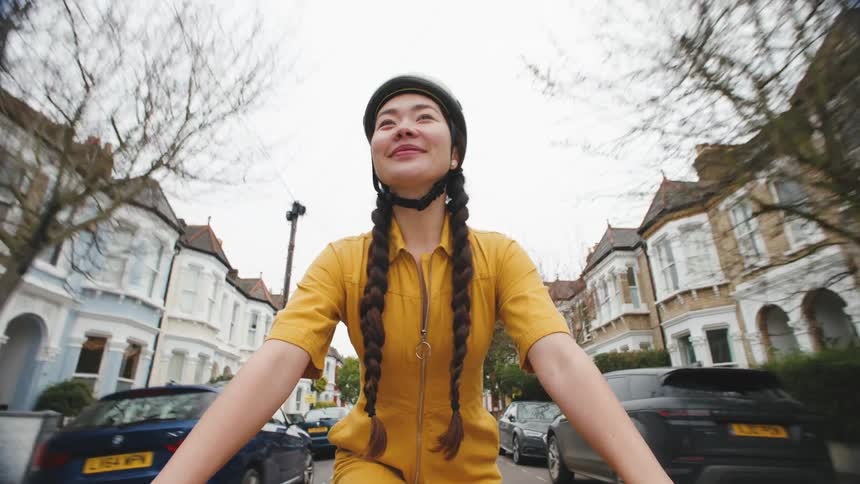 Female cyclist a bicycle on a residential street