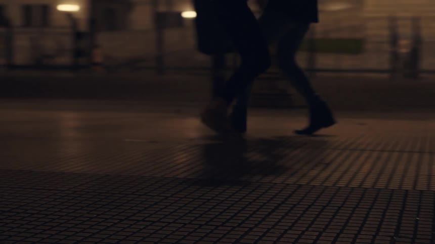 A couple dancing in a city street at night