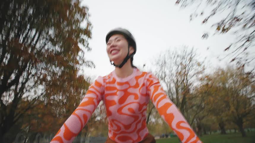 Portrait of a woman cycling in a forest on a cloudy day