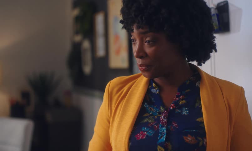 A woman teaches in front of a whiteboard and then writes on it