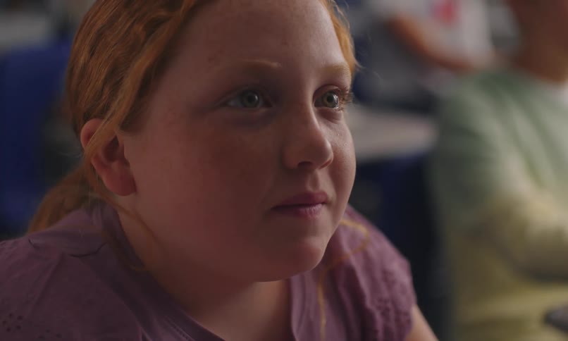 Portrait of a girl in the classroom looking to the side