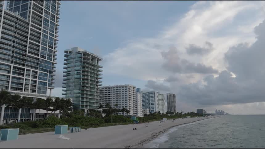 Aerial view of a residential area along the coast with highrise buildings under a cloudy sky