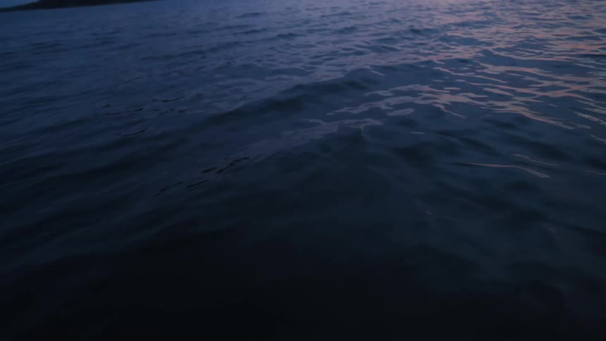 Light highlights small waves creating shadows a long distance from the coast
