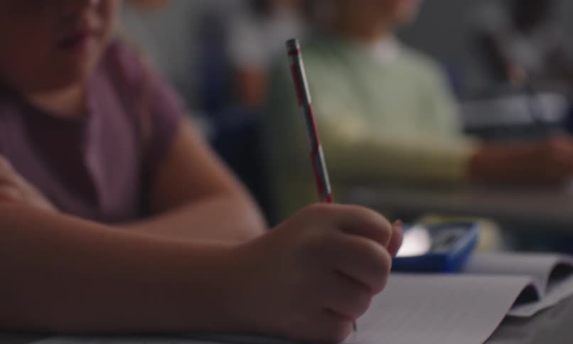 Students in a classroom writing with concentration