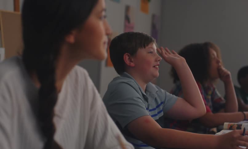 Students sitting in the classroom listen to their teacher