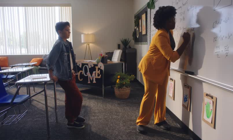 Teacher explaining a mathematical calculation on the board to a student