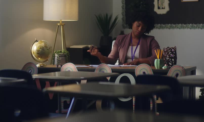 A woman sits at her desk and writes