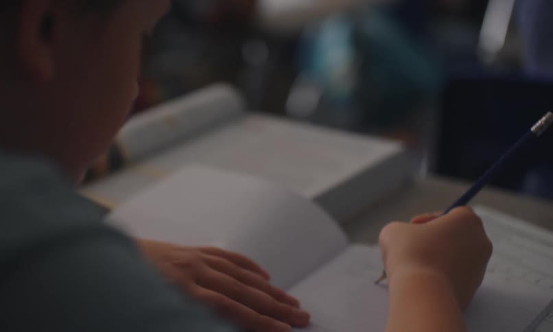 Young student works at their school desk in the classroom
