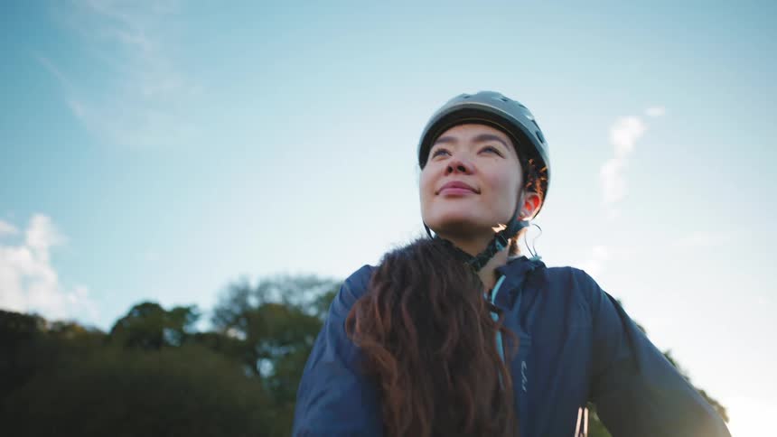 A woman looks determined and happy on a bicycle