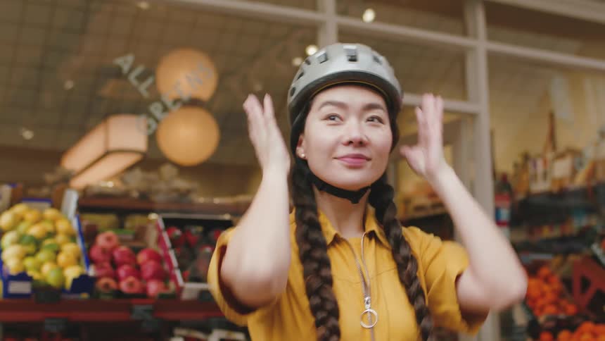 A woman puts on her bike helmet