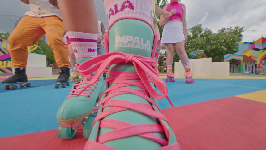 Close up of peoples legs on a colorful playground rollerblading
