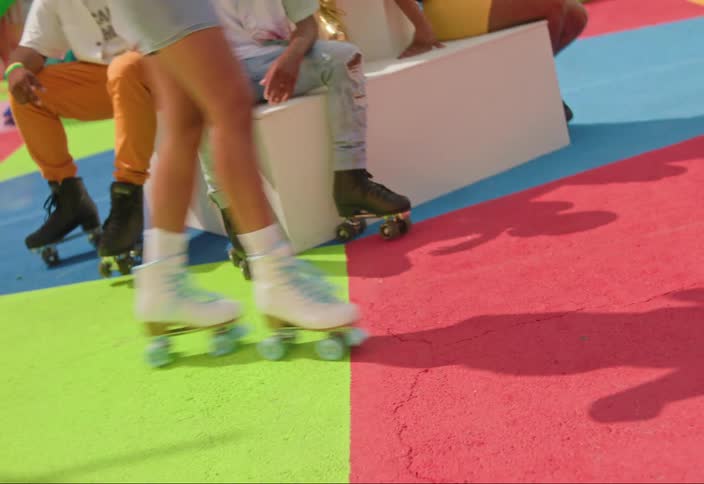Group of people are sitting and rollerblading