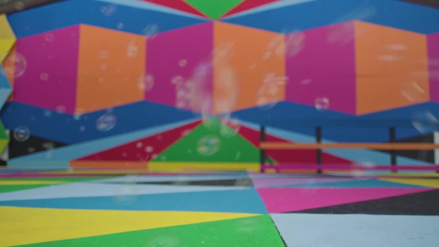 Soap bubbles flying in a colorful playground