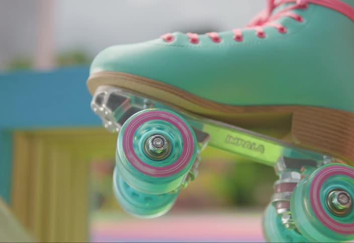 A person spins the wheels on their roller skate