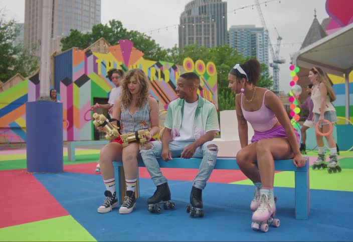 Group of people on a colorful playground with roller skates