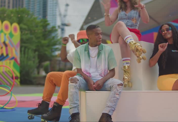 Group of friends sitting on a playground with all of them wearing roller skates