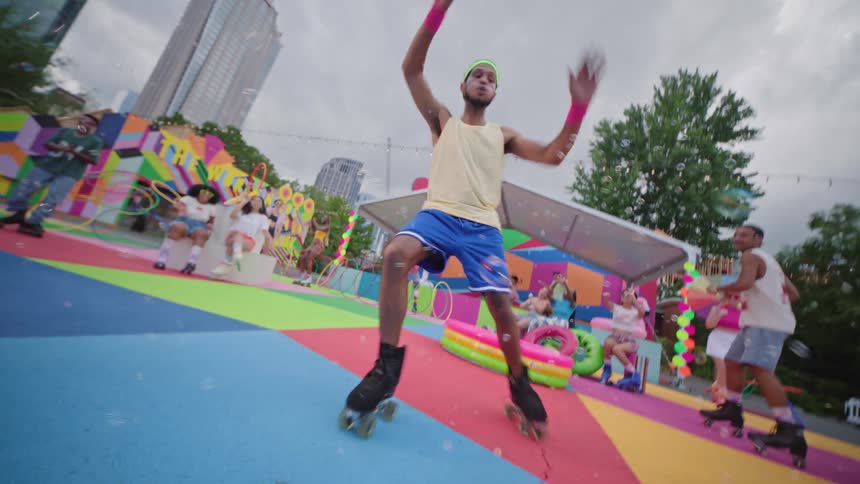 A person rollerblading in an urban park colorful geometric patterns adorn the ground