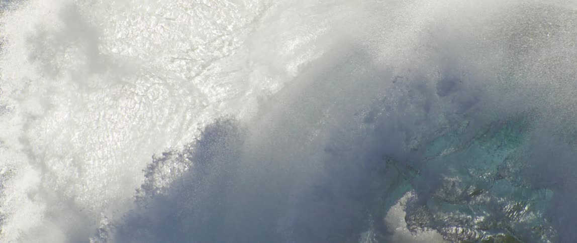 Ocean wave forming and breaking strongly exhaling foam