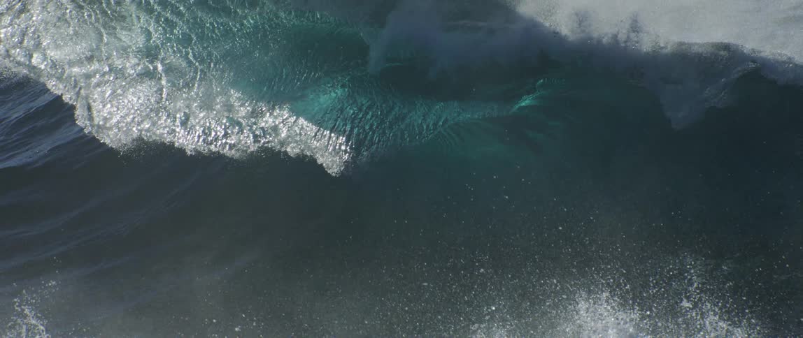 A very large wave crashes in the ocean