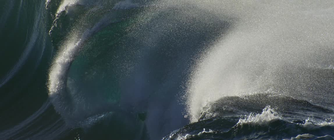 Large crashing wave sprays water into the air