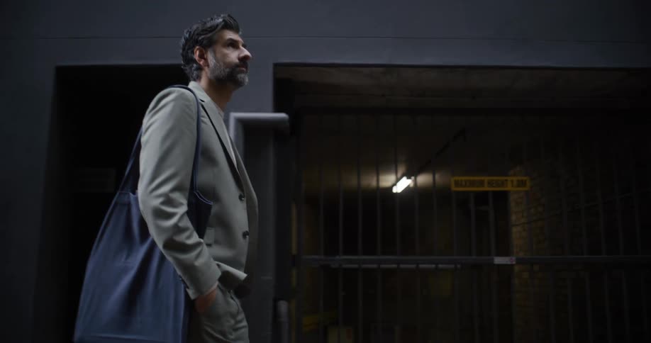 Man walks past barred up doors in the city