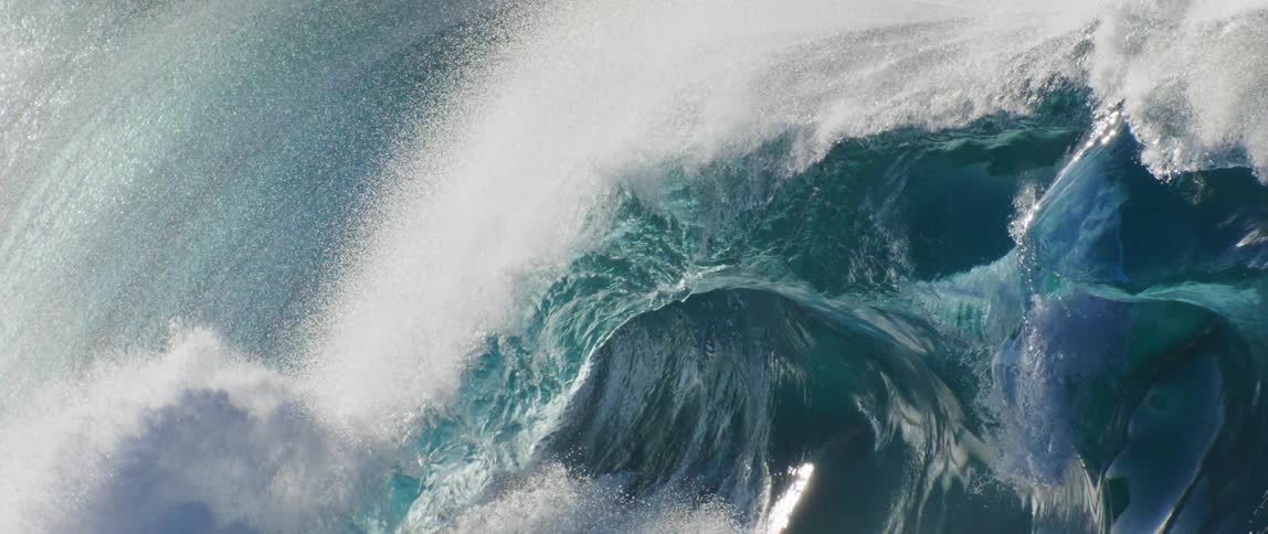 The sun reflects on the large waves