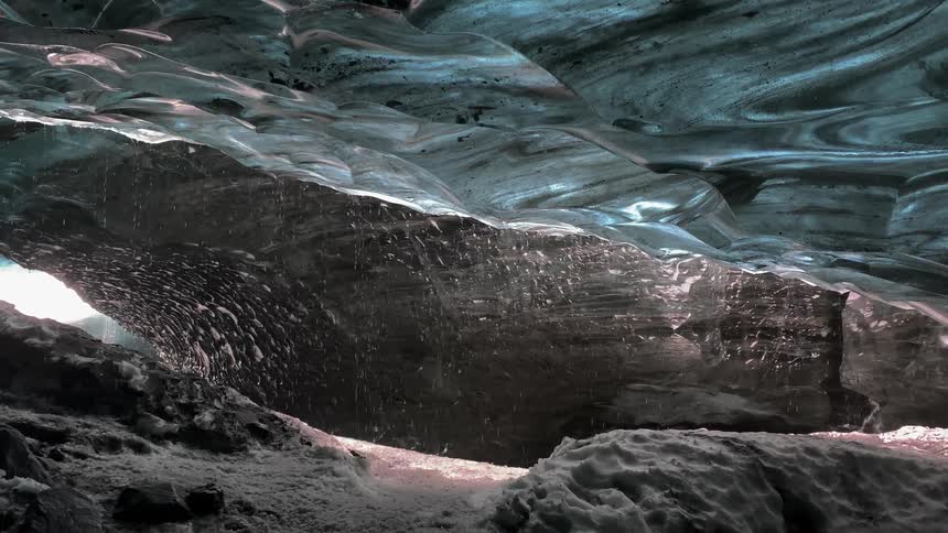 Melting snow falls inside of a cave