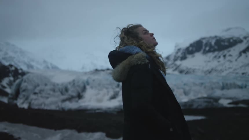 Woman enjoying the view in an environment surrounded by snowcapped mountains