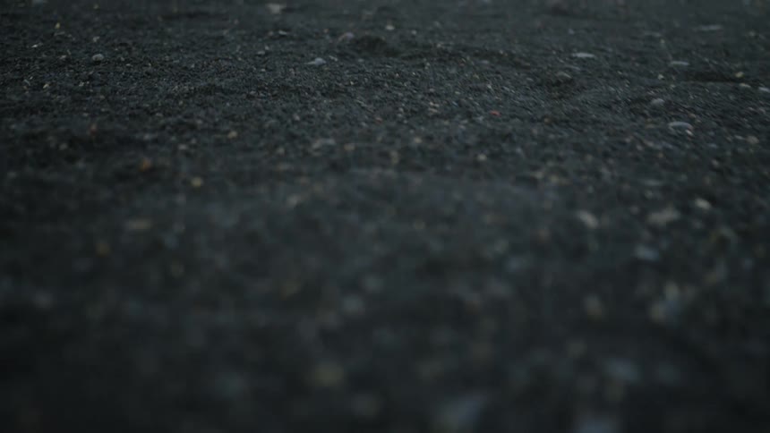 Turning to see a good amount of rocks in the asphalt