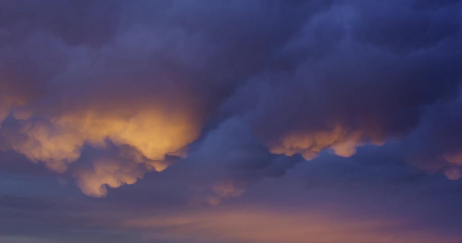 Cloudy sky with dark clouds and golden light tones