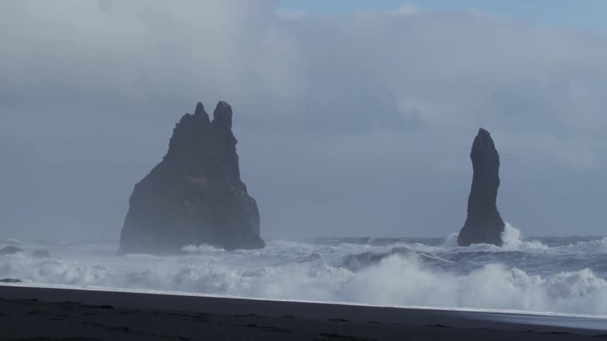 Waves crash against the rocks on the shore