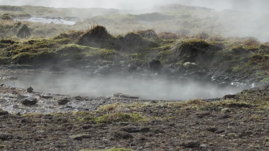 Steam rises from the hot springs