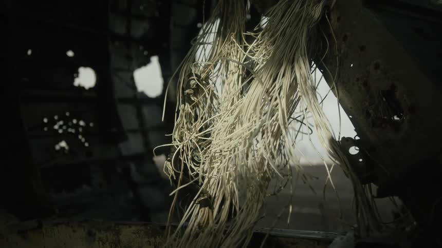 Wires emerge from a hole in a metal surface